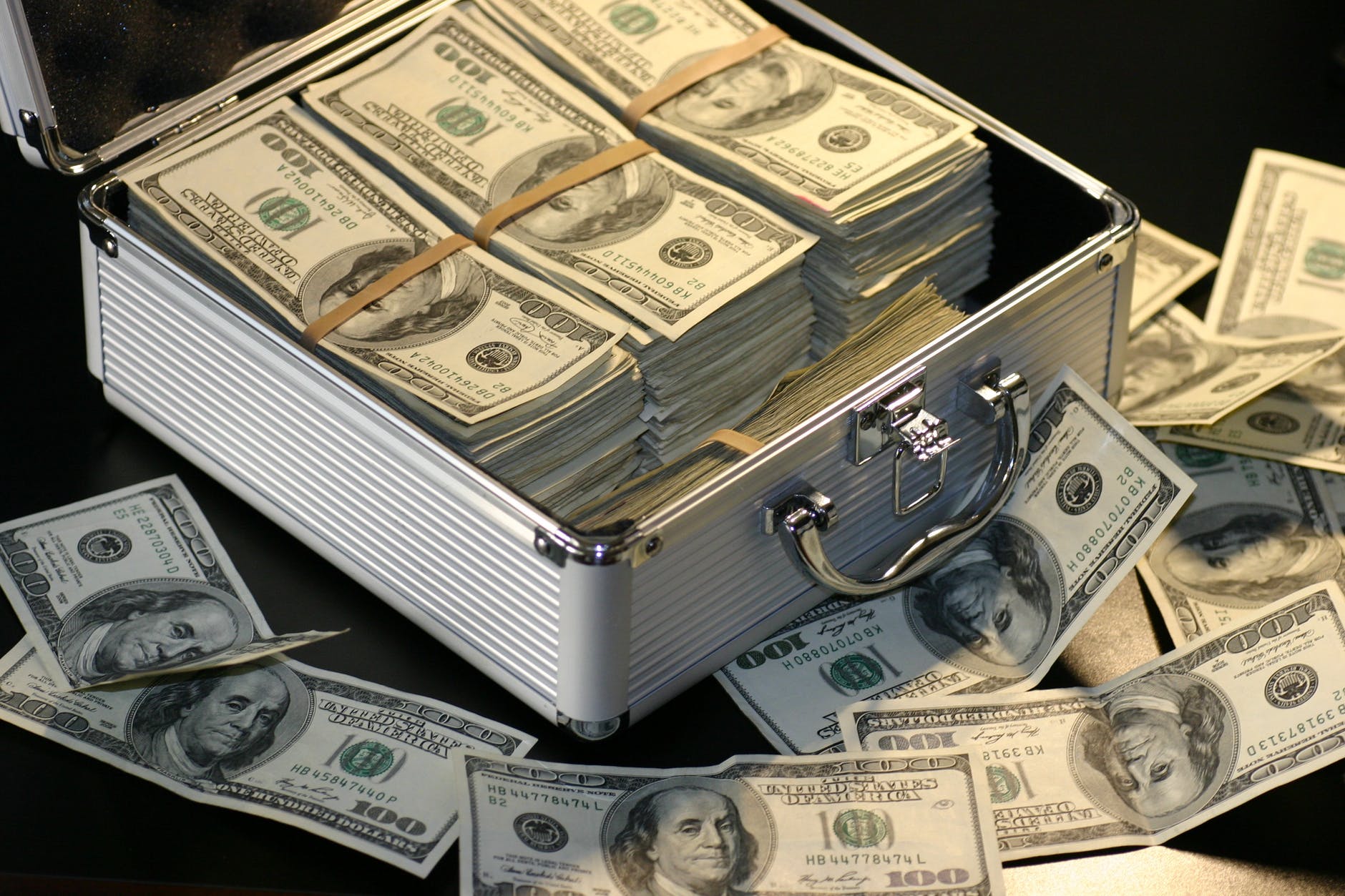 This is a picture of a drug company bribes of cash in a brief case that embodies a illegal bribes that come in many forms.